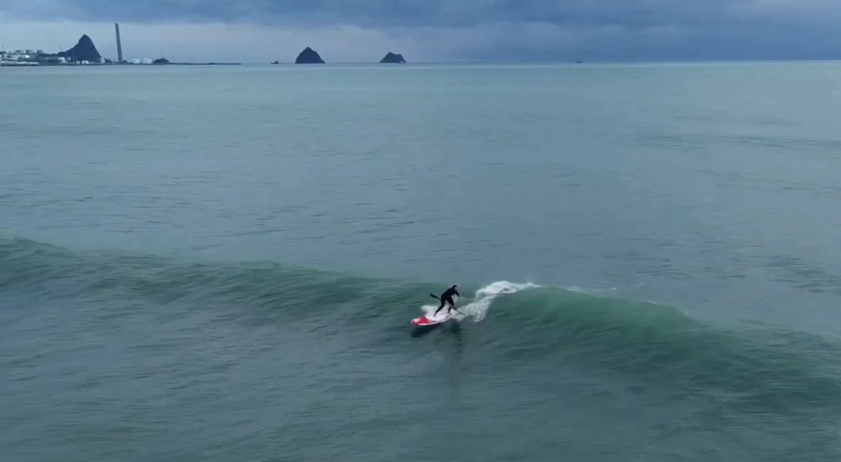 A clean Fitzroy wall with Ngā Motu and the port behind, Fitzroy surf spot, Taranaki / SH45, New Zealand.