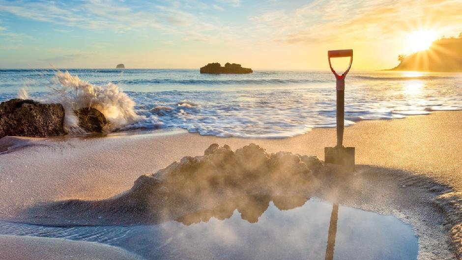 The shovel in the sand at sunrise. The two hours either side of low tide when the spring zone is open, Hot Water Beach surf s