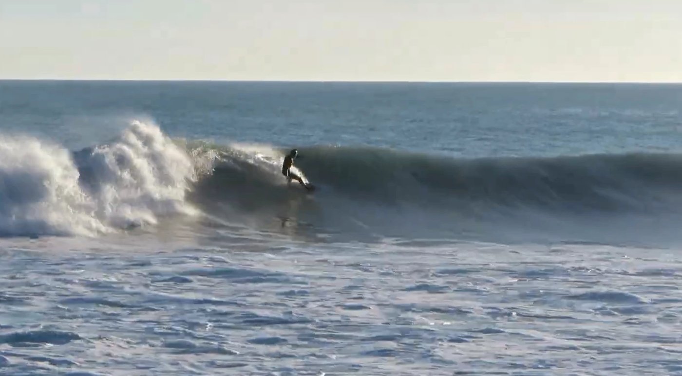 Setting the rail on a clean, fat left as the wave reels off down the point, Magnet Bay surf spot, Canterbury, New Zealand.