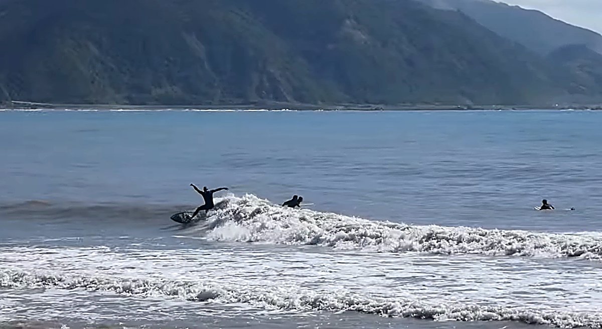 Laying into a turn with the Kaikōura mountains rising almost straight out of the sea behind, Mangamaunu surf spot, Kaikoura /