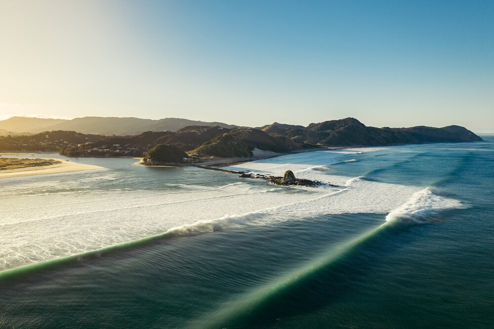 Sunrise over the bar and the harbour entrance, Mangawhai surf spot, Northland East, New Zealand.