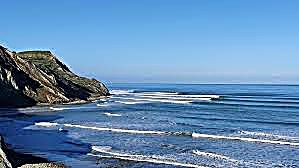 Swell lines fan into the remote bay below the North Canterbury hills, rarely a soul in sight, Mid Shore surf spot, Kaikoura /