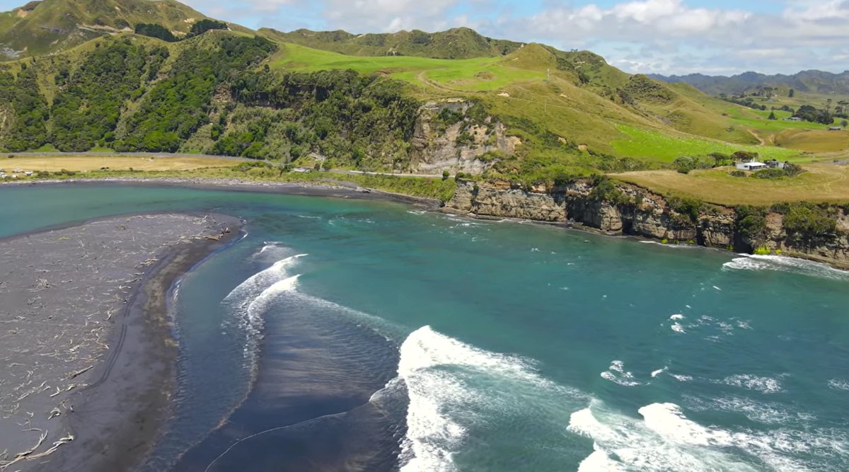 Whitewater peeling along the sandbar where the Mōkau River meets the sea, the classic river mouth setup, Mōkau surf spot, Tar