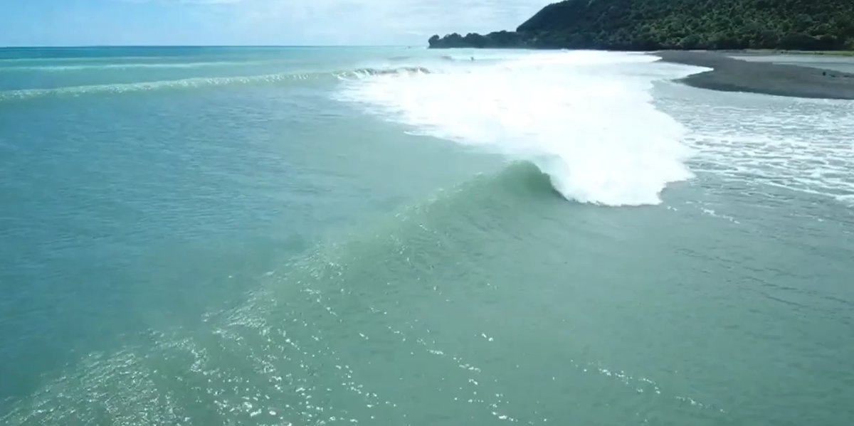 Aerial of the Motu point. The wave wraps off the headland and runs into the river mouth where the bar shapes, Motu surf spot,