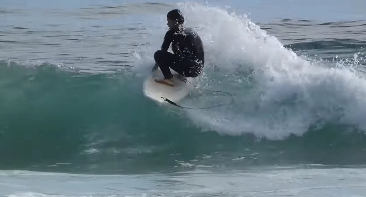 Crouched turn under the lip on a Tay Street wall, Mt Maunganui - Tay Street surf spot, Bay of Plenty, New Zealand.