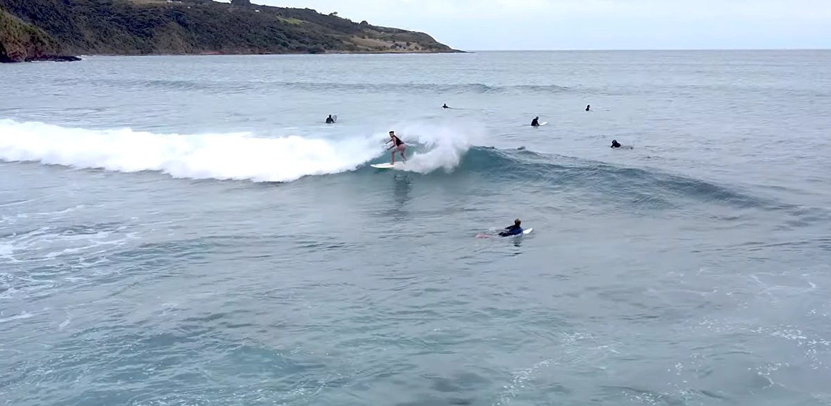 Drone shot of the lineup at Ngarunui. The wave is forgiving enough for improvers, with enough size at the south end on the ri