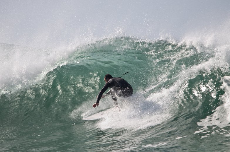 Pulling into a clean green wall as one of the reefs throws out a tidy little barrel, Ōkato surf spot, Taranaki / SH45, New Ze