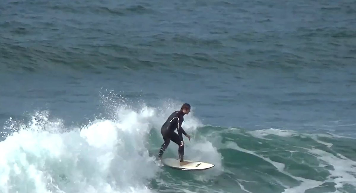 Riding the rolling beach break, Okiwi (GBI) surf spot, Auckland / Rodney, New Zealand.