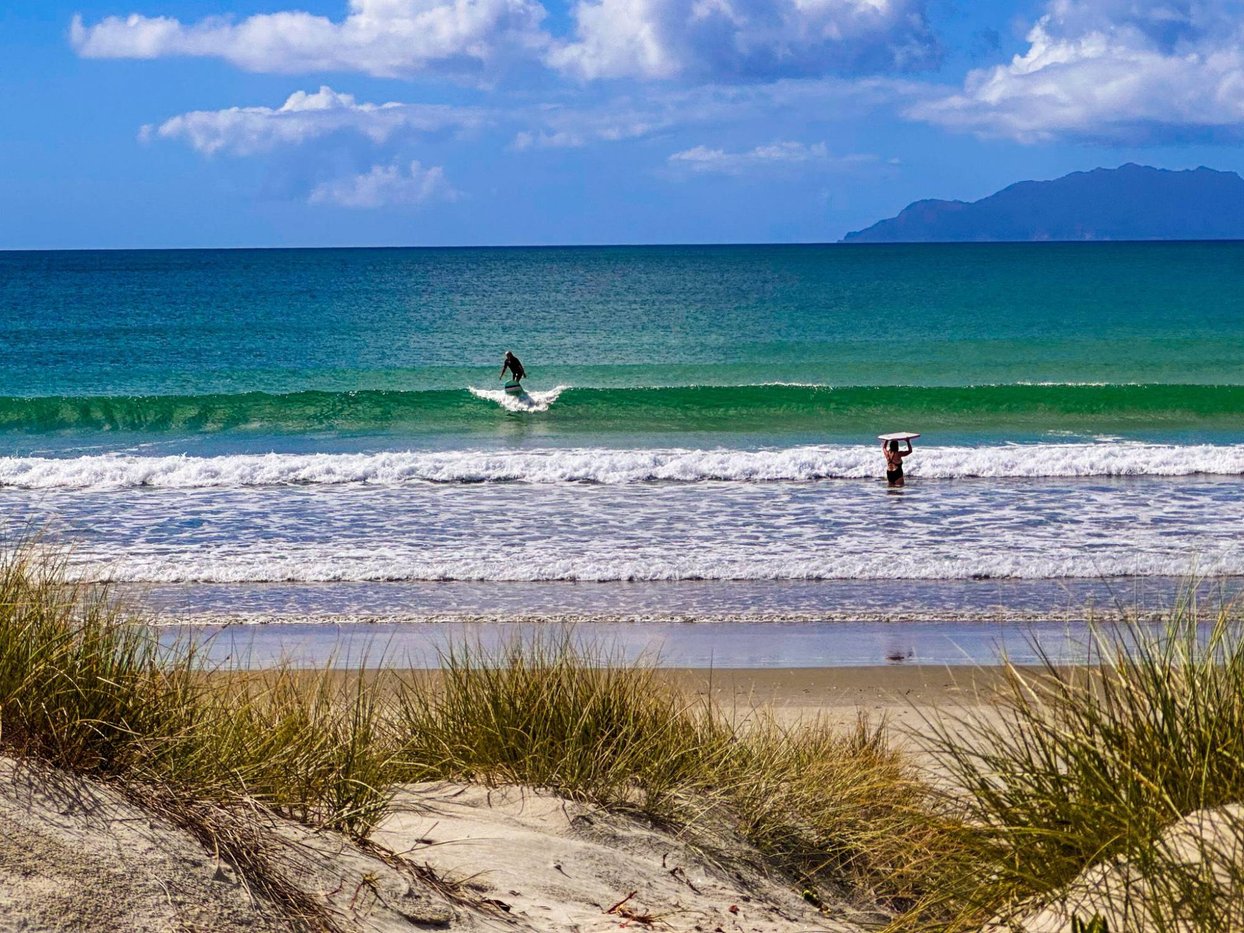 A clean day at the main beach, Hauturu Little Barrier on the horizon, Omaha surf spot, Auckland / Rodney, New Zealand.