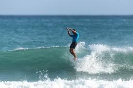 Longboarder noseriding a clean right-hand face at Pāpāmoa, Pāpāmoa surf spot, Bay of Plenty, New Zealand.
