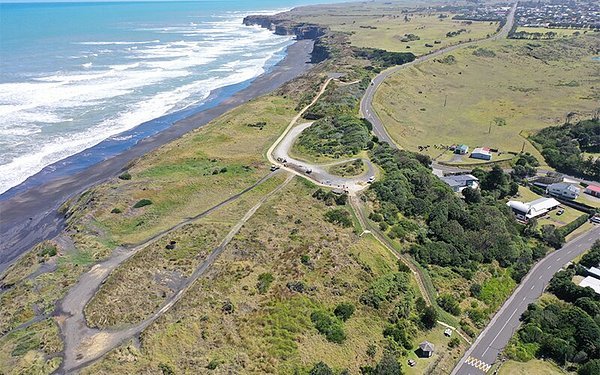 Aerial of the Pātea coast, the access road and the open surf beach, Pātea surf spot, Taranaki / SH45, New Zealand.