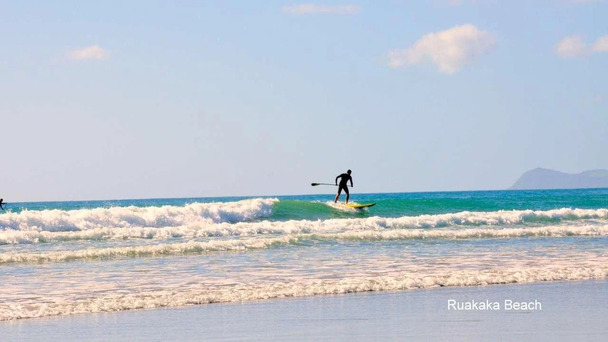 SUP session at the Surf Club end, Ruakākā surf spot, Northland East, New Zealand.