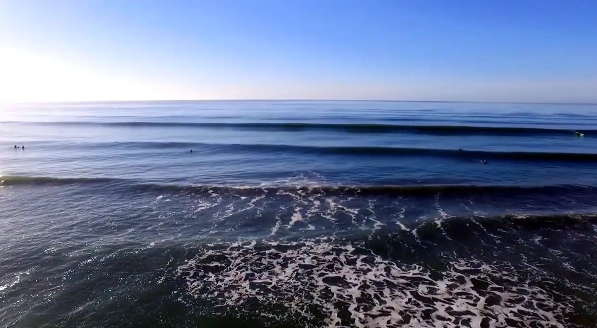 Glassy sets rolling through under blue sky, with plenty of peaks to go around, Waikuku Beach surf spot, Canterbury, New Zeala