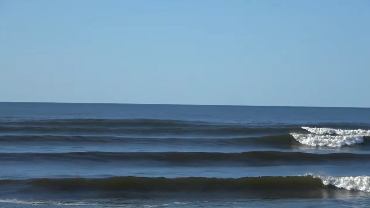 Glassy peaks line up under a bluebird sky on a classic clean Westport morning, Westport surf spot, West Coast South Island, N