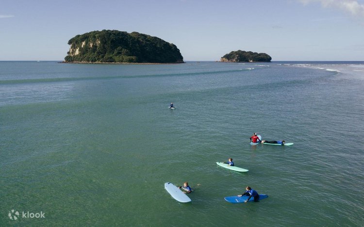 Surf school session on the main beach with Hauturu (Clark Island) behind. The friendly side of Whangamata, Whangamatā surf sp